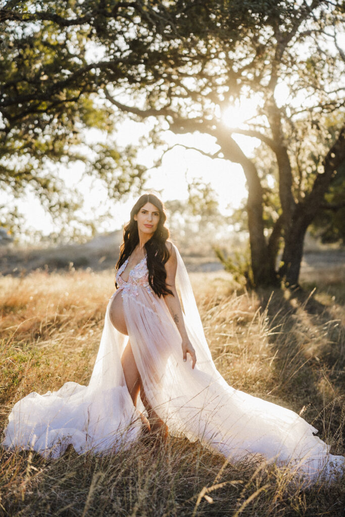 Stunning portrait of mom-to-be in a sun drenched field. 